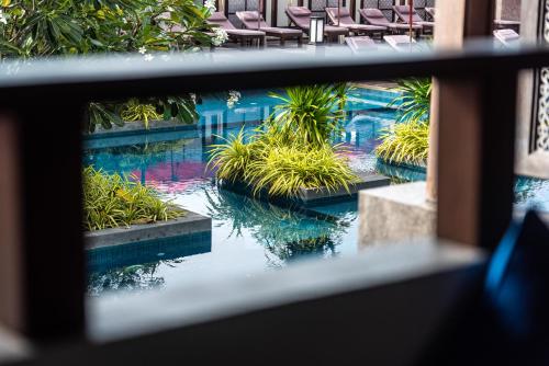 a view of a swimming pool from a window at Am Samui Palace in Lamai