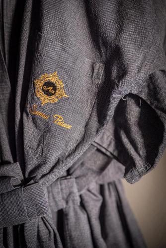 a black dress with a gold insignia on it at Am Samui Palace in Lamai