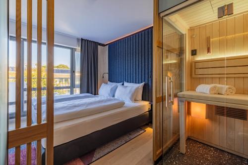 a hotel room with a bed and a balcony at The Flamingo in Timmendorfer Strand