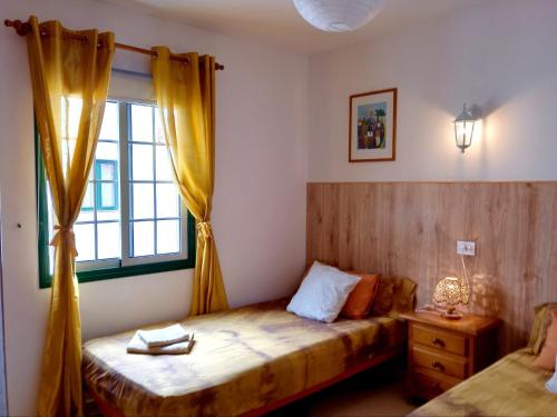 a bedroom with a bed and a window at il GABBIANO in Los Cancajos