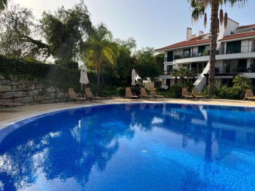 a large blue swimming pool next to a building at Vila Sol, Apartment 468 in Quarteira
