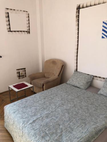 um quarto com uma cama e uma cadeira em Kiko 11B Room em Cracóvia