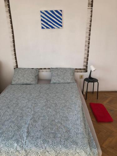 a bedroom with a bed with a blue and white comforter at Kiko 11B Room in Krakow