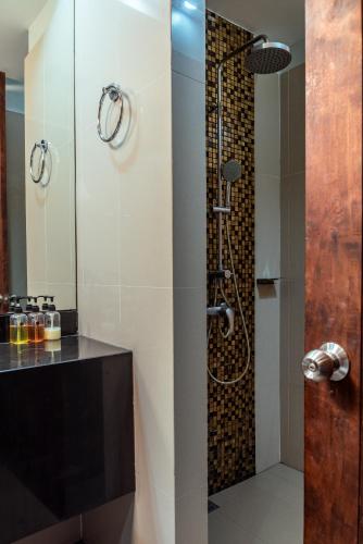 a bathroom with a shower with a glass door at Am Samui Palace in Lamai