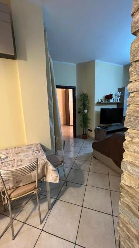 a living room with a couch and a table and chairs at Casa di Paola in Asti