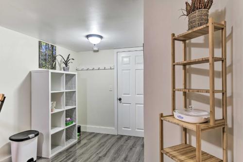 a room with white walls and wooden shelves at Cozy Studio Plus in Winooski with Home Gym! in Winooski