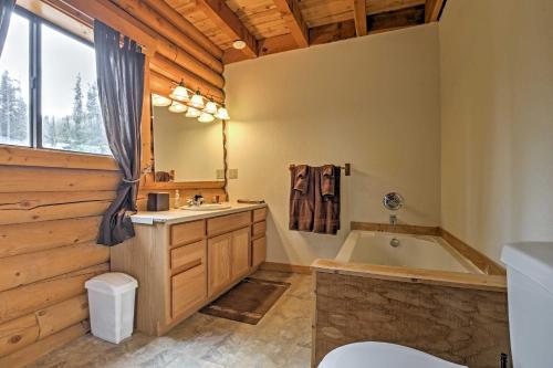 a bathroom with a tub and a sink and a bath tub at Expansive Alma Cabin with Hot Tub and Mountain Views! in Alma