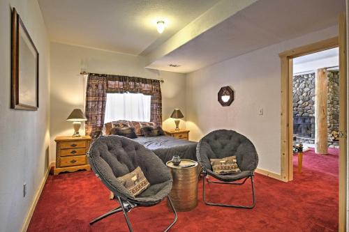 a bedroom with two chairs and a bed and a window at Expansive Alma Cabin with Hot Tub and Mountain Views! in Alma