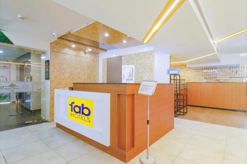 a reception desk in a store with a sign on it at FabHotel Aamantran in Hyderabad