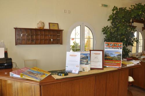 a wooden counter with signs on it in a room at Mazis Apartments in Agios Gordios