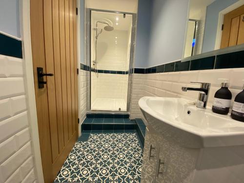 a bathroom with a sink and a shower at Harbour Inn in Amble