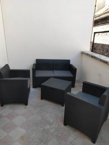 a room with couches and tables and a window at Don Aniello Alloggio Turistico in Sulmona