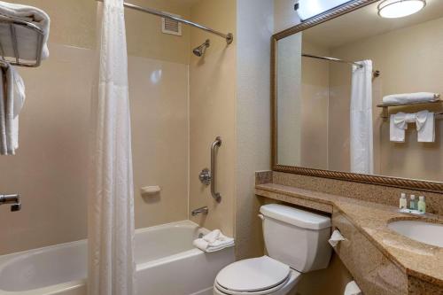 y baño con aseo, lavabo y ducha. en Quality Inn Placentia Anaheim Fullerton, en Placentia