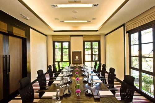 a long long table in a room with windows at Banyan Tree Samui in Lamai
