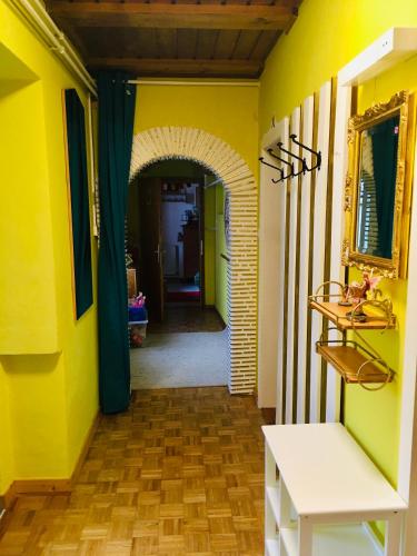 a hallway of a house with yellow walls and a table at Familienapartments mit Balkon oder Terrasse und Garten in Ober-Lembach