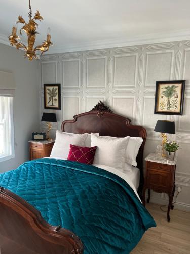 a bedroom with a bed with a blue blanket at Coppergate Apartments in York