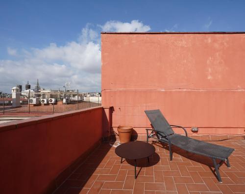 a chair and a table sitting on a roof at numa I Seda Apartments in Barcelona