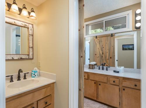 a bathroom with a sink and a mirror at Cedar Upper Condominium 3 Bedroom condo in Estes Park