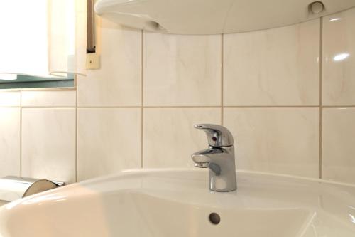 a sink with a faucet in a bathroom at Ferienwohnung Sonnenhang-Hartmann in Olsberg