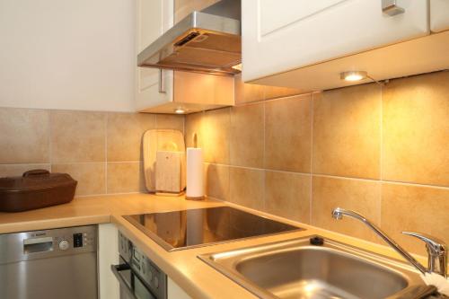 a kitchen with a sink and a counter top at Ferienwohnung Sonnenhang-Hartmann in Olsberg