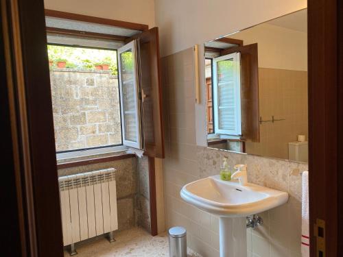 a bathroom with a sink and a mirror at Casa de Santa Bárbara - Cinfães in Cinfães