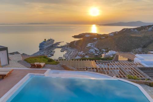 a villa with a swimming pool and a cruise ship at Manolia View Mykonos in Tourlos