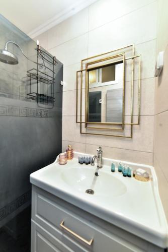 a bathroom with a sink and a mirror at SOKOLOV Vacation Apartments by the sea in nahariya in Nahariyya