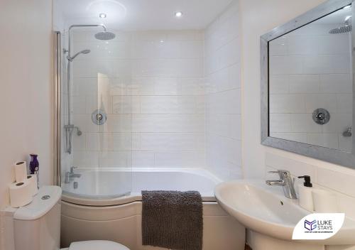 a bathroom with a tub and a sink and a toilet at Luke Stays - Grosvenor Road in Jesmond