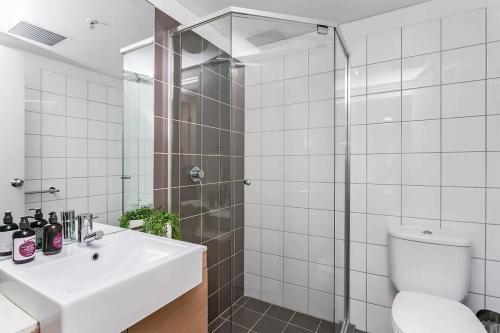 a bathroom with a shower and a sink and a toilet at City Centre Apt - 3 Bed/Parking/CBD/WiFi in Adelaide