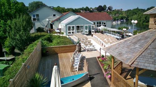 an aerial view of a wedding ceremony on a deck with a boat at The Riverside inn in Saltford