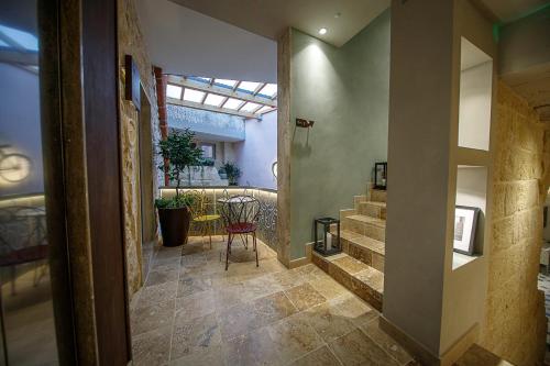 a hallway with a table and stairs in a house at The Heritage Boutique Accommodation in Rabat