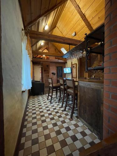 a restaurant with a bar with a checkered floor at Kauba Apartment in Viljandi