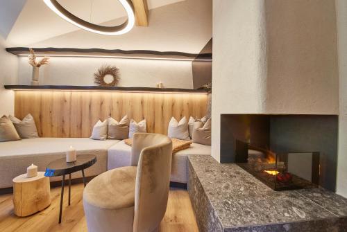 a hotel room with a bed and a fireplace at Penthouse Appartement Fire & Stone in Saalbach-Hinterglemm