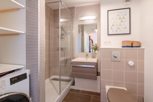 a bathroom with a shower and a toilet and a sink at Superb family duplex clos to Disneyland in Bussy-Saint-Georges