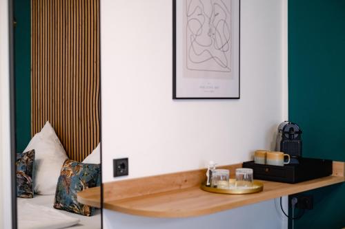 a room with a bed and a wooden shelf at Alex & Rine - Pension Zum Alten Strom in Warnemünde
