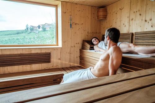 a man and a woman in a sauna at das MEISTER in Riegersburg