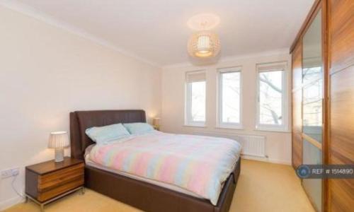 a bedroom with a bed and a window at City Riverview 1/2 Bedroom Apartment in London