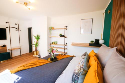 a bedroom with a bed with a blanket on it at Alex & Rine - Pension Zum Alten Strom in Warnemünde