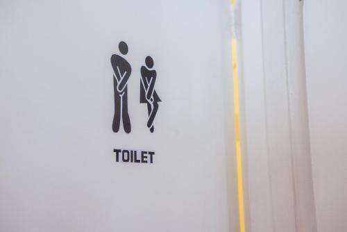 a sign for a toilet on a wall at 4 BEDROOM HOUSE PARKING & GARDEN NEAR CENTRAL LONDOn in London