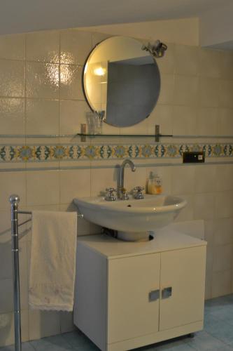 a bathroom with a sink and a mirror at Vacanze al Mare Patrizia's Sweet Home in Terme Vigliatore