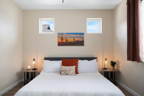 a bedroom with a large white bed with two tables at Stunning Views + Hot Tub + Location! 3 bed/3 bath in Cottonwood