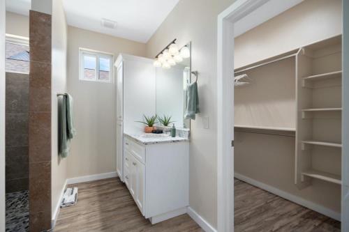 a bathroom with a sink and a walk in closet at Stunning Views + Hot Tub + Location! 3 bed/3 bath in Cottonwood