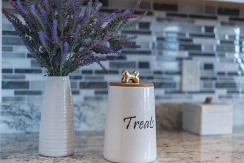 two white vases with purple flowers on a counter at Stunning Views + Hot Tub + Location! 3 bed/3 bath in Cottonwood