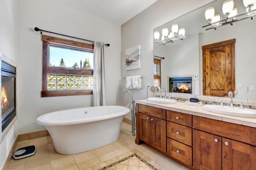 a bathroom with two sinks and a tub and a fireplace at Ski In Out Luxury Villa #492 With Hot Tub & Great Views - 500 Dollars Of FREE Activities & Equipment Rentals Daily in Winter Park
