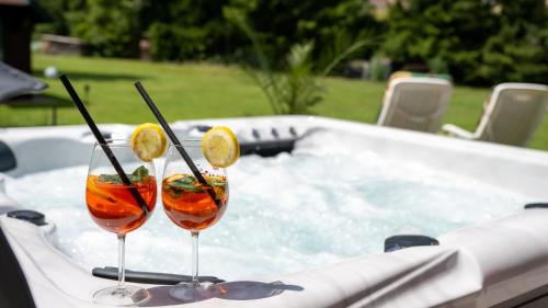 two cocktails in glasses sitting in a hot tub at Ferienhaus Rauscher in Sittersdorf