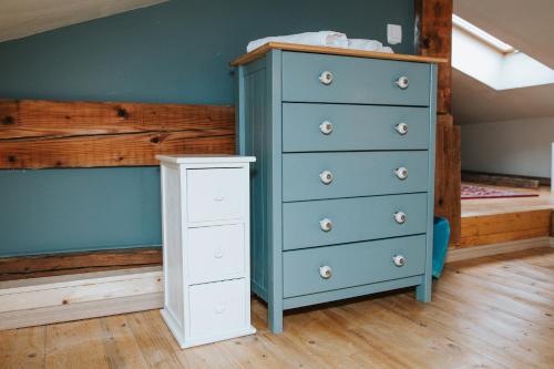 a bedroom with a blue dresser and a bunk bed at Hisa Gradnikova in Tolmin