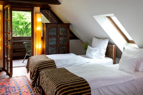 two beds in a room with a attic at Klekotki Spa & Resort in Klekotki