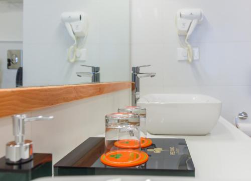 a kitchen with a sink and a counter with orange plates at Pelyang Boutique in Thimphu