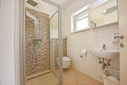 a bathroom with a shower and a toilet and a sink at APP Laura with Common Pool in Nova Vas