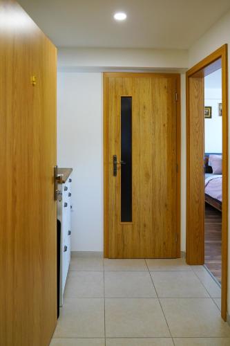 a room with a door and a bedroom with a bed at Apartmán Praha Břevnov in Prague